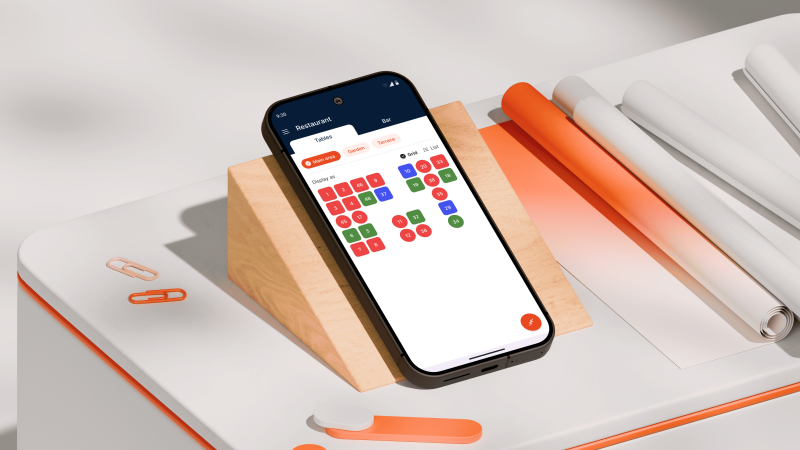 A phone on top of a table with a slight inclination.